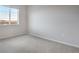 Well-lit bedroom featuring a window and carpet at 16748 W 93Rd Pl, Arvada, CO 80007