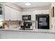 Modern kitchen with white cabinets and stainless steel appliances at 14500 E 2Nd Ave # 105A, Aurora, CO 80011