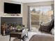 Living room with fireplace, tv, seating, and view of outside at 14500 E 2Nd Ave # 105A, Aurora, CO 80011