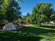 Landscaped backyard with play area and fire pit at 6051 S Telluride Cir, Aurora, CO 80016