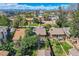 Aerial view of the neighborhood showcasing well-maintained homes, mature trees and city views at 2050 S Lincoln St, Denver, CO 80210