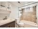 Bathroom with updated vanity, tiled shower-tub combo, and glass block window for added light at 2050 S Lincoln St, Denver, CO 80210
