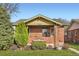 Charming brick home with well-maintained lawn and inviting front porch at 2050 S Lincoln St, Denver, CO 80210