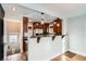 Eat-in kitchen with stainless steel appliances and stone counter, with a great view of the basement door at 2050 S Lincoln St, Denver, CO 80210