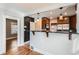 Modern kitchen with granite countertops and stainless steel appliances, with an open bar overlooking living room at 2050 S Lincoln St, Denver, CO 80210