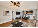 Open-concept living room featuring hardwood floors and view of the kitchen, dining area and bathroom at 2050 S Lincoln St, Denver, CO 80210
