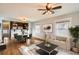 Bright living room boasts hardwood floors, modern furnishings, and an open floor plan to the kitchen at 2050 S Lincoln St, Denver, CO 80210