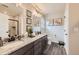 Bathroom showcasing double sink vanity with granite countertop, and framed botanical wall art at 17855 E 103Rd Ave, Commerce City, CO 80022