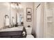 Bathroom featuring vanity with granite countertop and framed buffalo wall art at 17855 E 103Rd Ave, Commerce City, CO 80022