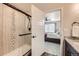 Shower with decorative tiling and matte black hardware seen from bathroom with granite countertop at 17855 E 103Rd Ave, Commerce City, CO 80022