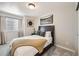 Bedroom featuring carpet, neutral walls, and a bed with wooden headboard and decorative pillows at 17855 E 103Rd Ave, Commerce City, CO 80022