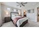 Bright bedroom featuring soft carpet, contemporary ceiling fan, and view to ensuite bathroom at 17855 E 103Rd Ave, Commerce City, CO 80022