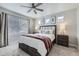 Bright bedroom with modern ceiling fan, neutral walls, and picture rail above the comfortable queen-size bed at 17855 E 103Rd Ave, Commerce City, CO 80022
