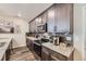 Elegant kitchen featuring granite countertops, modern appliances, and stylish backsplash at 17855 E 103Rd Ave, Commerce City, CO 80022
