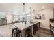 Open-concept kitchen with a granite island, stainless steel appliances, and hardwood floors at 17855 E 103Rd Ave, Commerce City, CO 80022