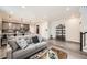 Spacious living room area featuring contemporary decor and an open layout to the kitchen at 17855 E 103Rd Ave, Commerce City, CO 80022