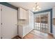 Bright kitchen with white cabinets and sliding door at 456 Pluto Ct, Lone Tree, CO 80124