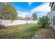 Backyard with a white fence, green grass, and some bushes along the perimeter at 19153 E 51St Ave, Denver, CO 80249