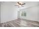 Bright bedroom featuring a ceiling fan and a large window, offering a serene and inviting space at 19153 E 51St Ave, Denver, CO 80249
