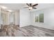 Open room featuring stylish flooring, ceiling fan, and a window looking out into the neighborhood at 19153 E 51St Ave, Denver, CO 80249