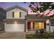 Inviting two-story home featuring a red front door, well-maintained lawn, and attached two-car garage at 19153 E 51St Ave, Denver, CO 80249