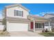 Charming two-story house with a red door, an attached garage, and landscaped front yard on a clear day at 19153 E 51St Ave, Denver, CO 80249