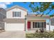 Attractive home with a red front door, well-kept lawn, and an attached two-car garage at 19153 E 51St Ave, Denver, CO 80249