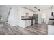 Modern kitchen with white cabinets, stainless steel appliances, and gray backsplash, providing easy access to laundry at 19153 E 51St Ave, Denver, CO 80249