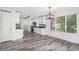 Open kitchen area boasting white cabinets, black countertops, stainless steel appliances, and natural light at 19153 E 51St Ave, Denver, CO 80249