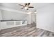 Bright open room with ceiling fan, stylish flooring, and hallway access at 19153 E 51St Ave, Denver, CO 80249