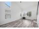 Bright and airy living room featuring wood-look floors, large windows, and vaulted ceilings with a fish tank at 19153 E 51St Ave, Denver, CO 80249