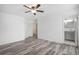 Spacious main bedroom with a ceiling fan and ensuite bathroom access, providing comfort and convenience at 19153 E 51St Ave, Denver, CO 80249