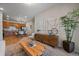 Open-concept living area with kitchen view, featuring modern decor and hardwood flooring at 1841 S Dunkirk St # 203, Aurora, CO 80017