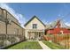 Inviting backyard with a covered patio, green grass, and wood fence, perfect for outdoor entertaining at 2530 N Franklin St, Denver, CO 80205