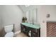 Bathroom featuring double sinks with a frosted glass counter, modern mirrors, and ample storage at 2530 N Franklin St, Denver, CO 80205