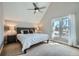 Bright bedroom with vaulted ceilings, a ceiling fan, a cozy bed, and lots of natural light at 2530 N Franklin St, Denver, CO 80205