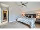 Comfortable bedroom with neutral carpet, a vaulted ceiling, a fan, and an open door to the Primary bathroom at 2530 N Franklin St, Denver, CO 80205