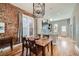 Inviting dining area adjacent to the kitchen, featuring exposed brick and hardwood floors at 2530 N Franklin St, Denver, CO 80205