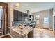 Modern kitchen with dark cabinets, granite countertops, and stainless steel appliances at 2530 N Franklin St, Denver, CO 80205