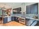 Well-appointed kitchen with stainless steel appliances, a stylish backsplash, and hardwood floors at 2530 N Franklin St, Denver, CO 80205
