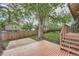 Backyard features a wood deck, brick patio, large tree, and a wood fence at 18984 E Kent Cir, Aurora, CO 80013
