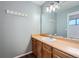 Bathroom features a single sink vanity with wood cabinets and a large mirror with lighting at 18984 E Kent Cir, Aurora, CO 80013
