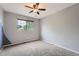 Bright bedroom with gray carpet, a ceiling fan and a backyard view at 18984 E Kent Cir, Aurora, CO 80013