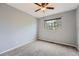 Bedroom with gray carpet, ceiling fan and views of lush backyard trees at 18984 E Kent Cir, Aurora, CO 80013