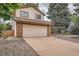 Two-story house with a spacious driveway and a low maintenance rock garden at 18984 E Kent Cir, Aurora, CO 80013