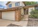 Inviting two-story home, showing the house number, brick accents and steps leading up to the front door at 18984 E Kent Cir, Aurora, CO 80013