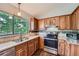 Kitchen featuring modern appliances, wooden cabinetry, and great natural light at 18984 E Kent Cir, Aurora, CO 80013