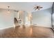 Open-concept living room featuring wood floors, neutral walls, and a ceiling fan at 18984 E Kent Cir, Aurora, CO 80013