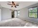 Spacious main bedroom with private bath access, gray carpet and a ceiling fan at 18984 E Kent Cir, Aurora, CO 80013