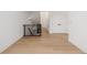 Well-lit hallway features modern railing, hardwood floors, and white paneled doors at 2361 Junegrass Ln, Superior, CO 80027